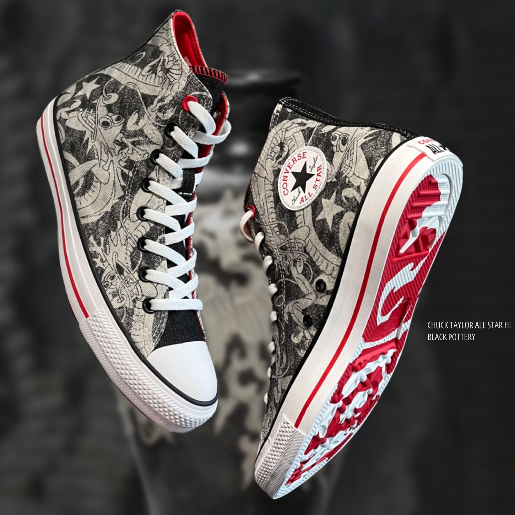 Converse high-tops with a black and white dragon print and red sole details