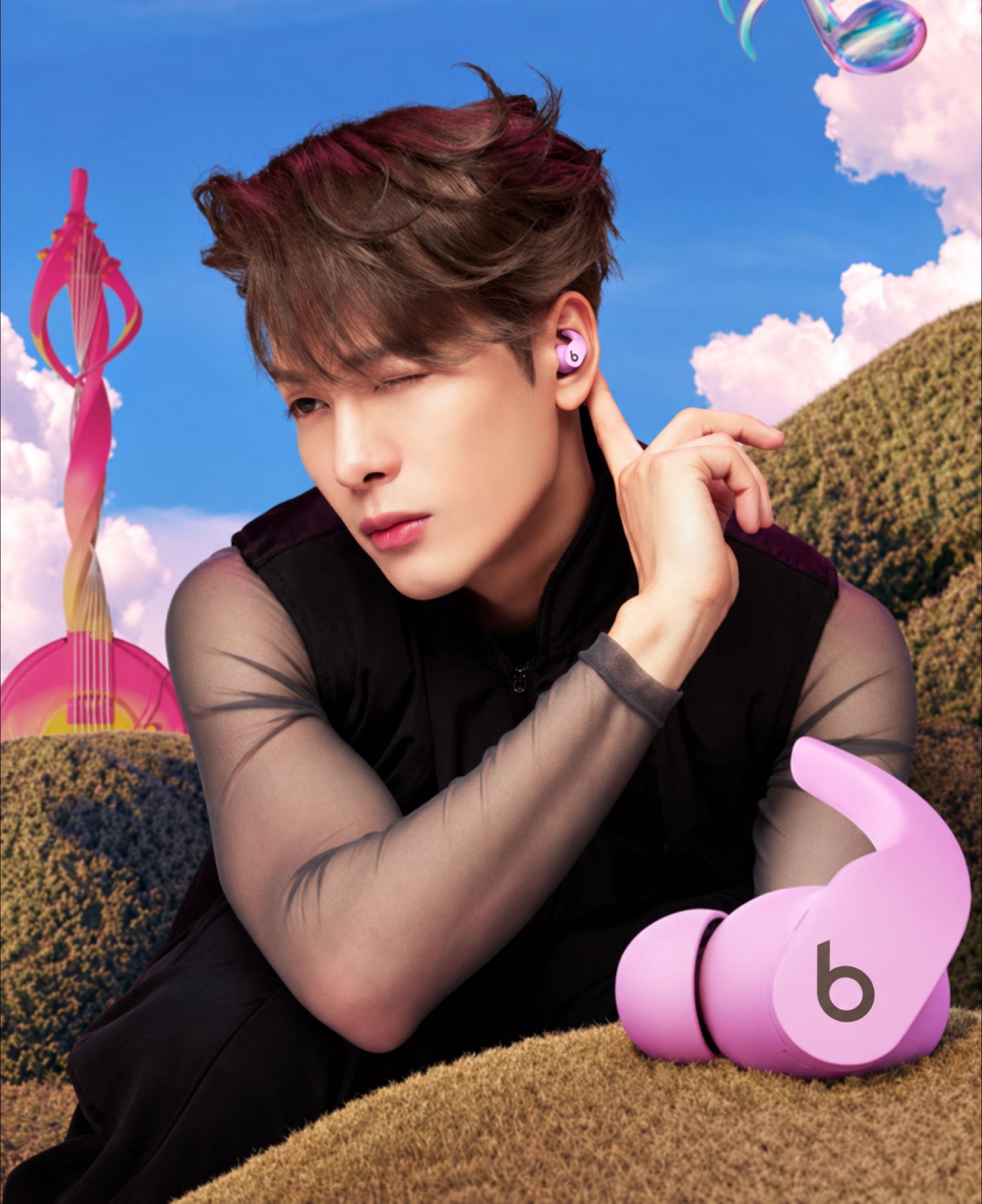 Jackson Wang with pink Beats Fit Pro earbuds in Beats Wonderland