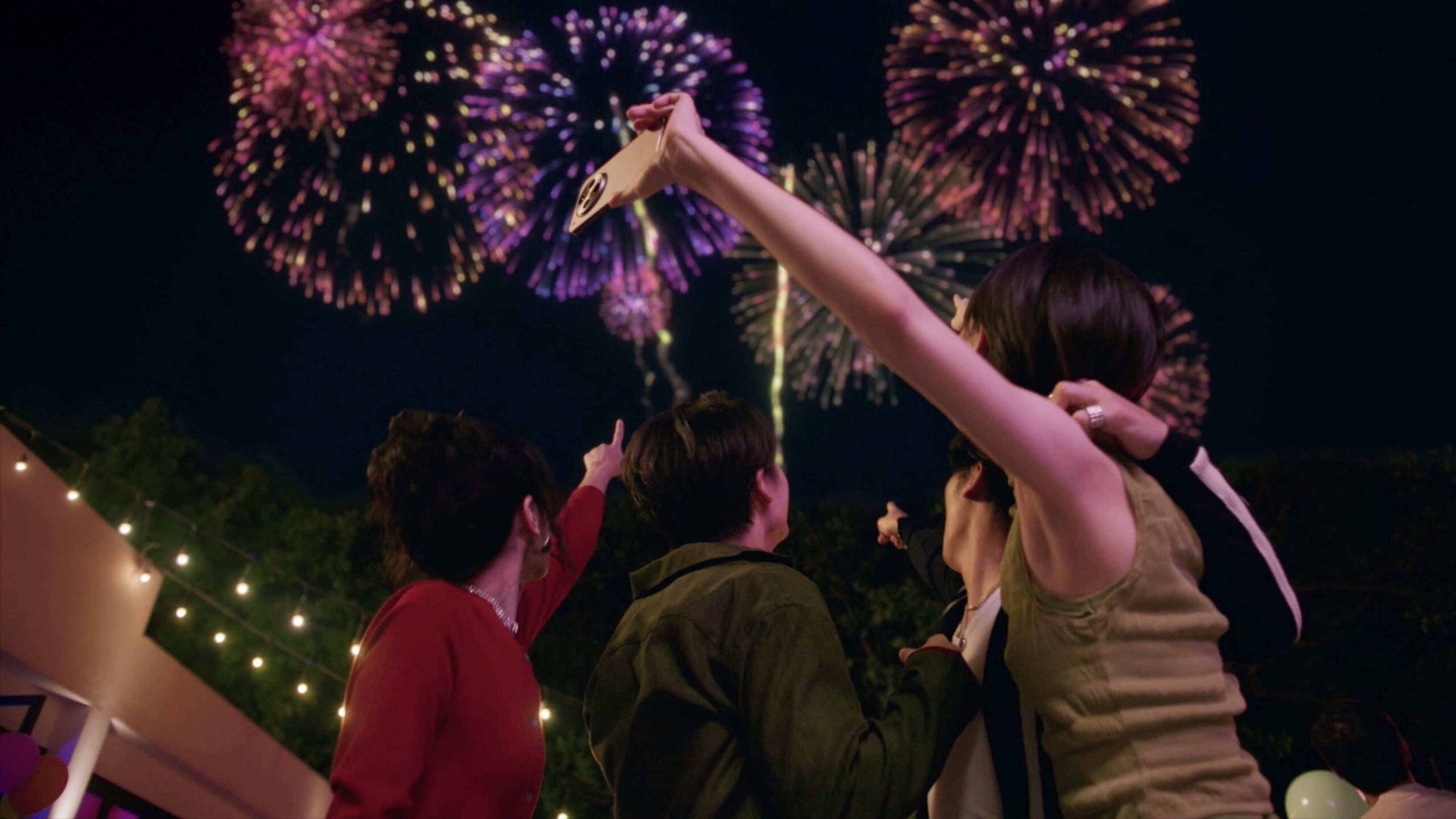 Film still of friends watching fireworks together