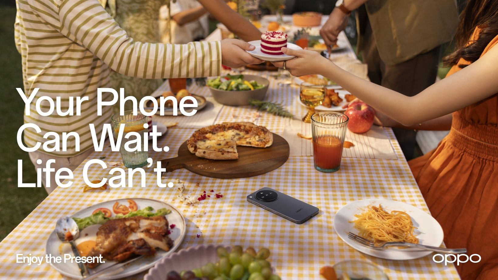 Key visual of a shared holiday meal with a phone set aside