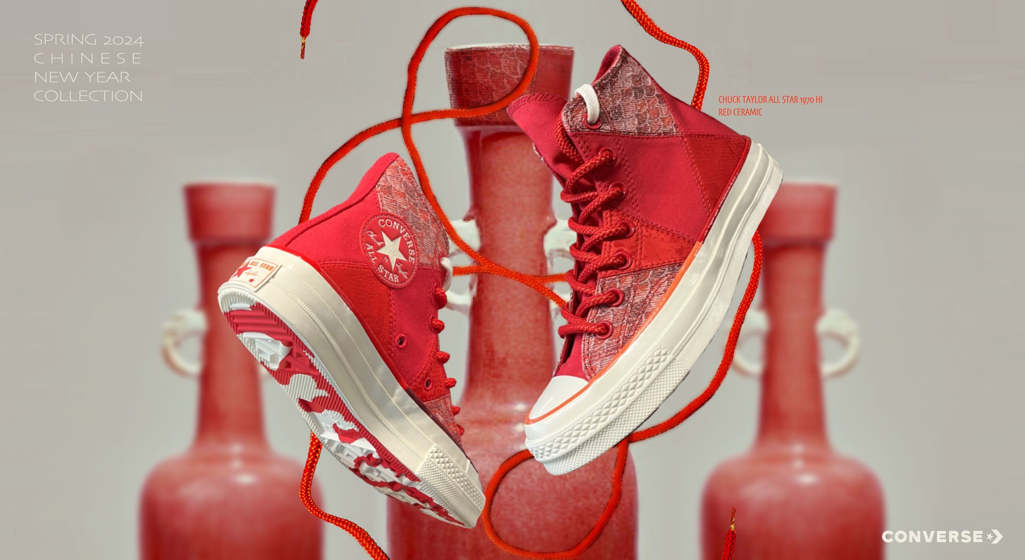 Red Converse Year of the Dragon high-tops suspended by red laces among red vases