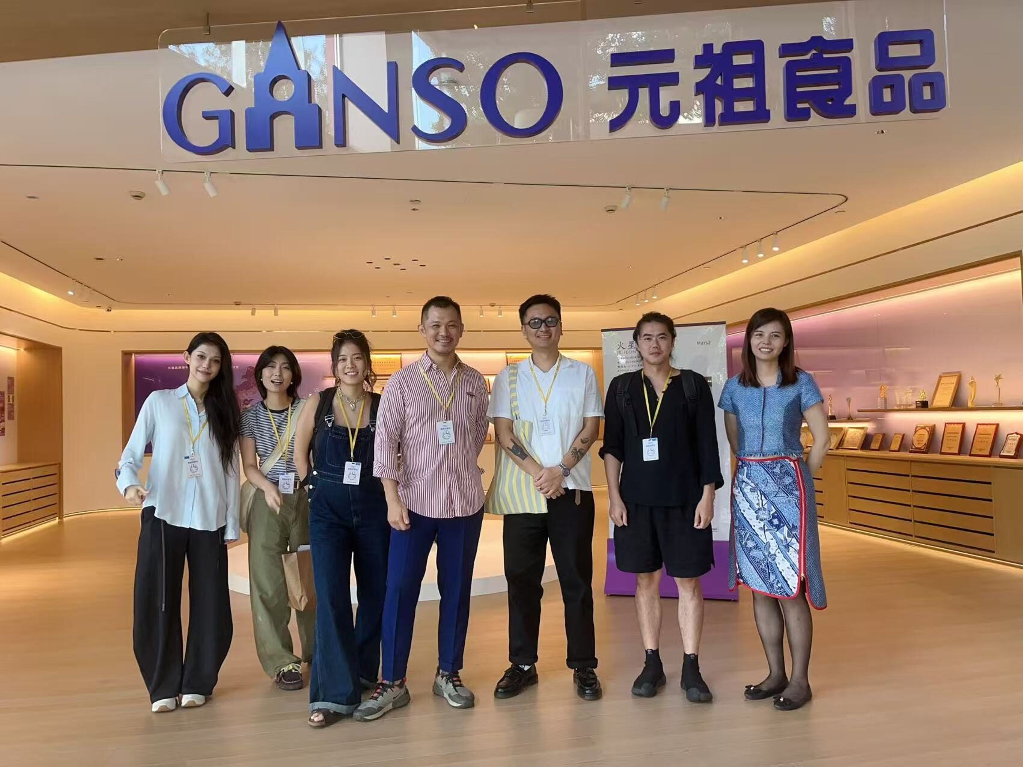 Ugly and GANSO team standing in front of the GANSO sign