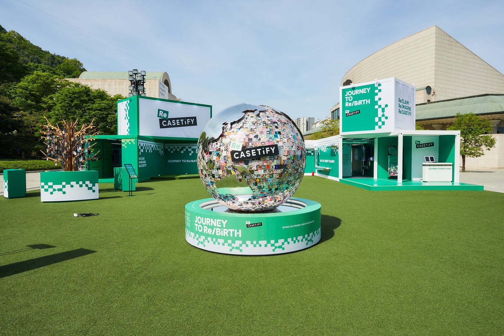 Mirrored globe covered in recycled phone cases on the lawn in Seoul
