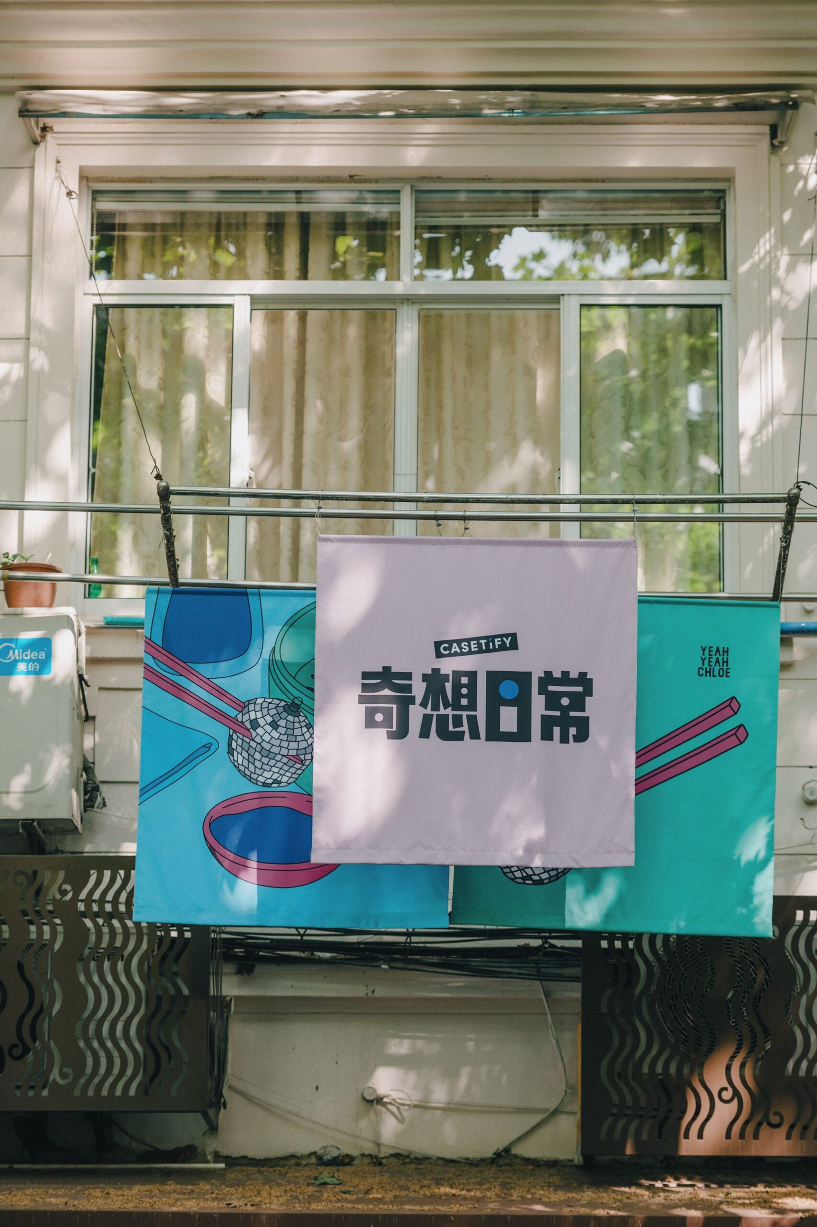 Campaign banners with the lowercase i logotype hung from a balcony