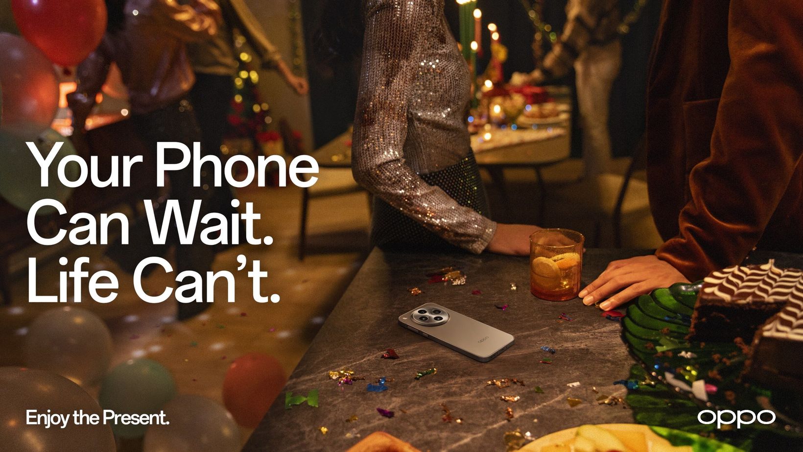 Key visual of a festive table with a phone left beside the plates