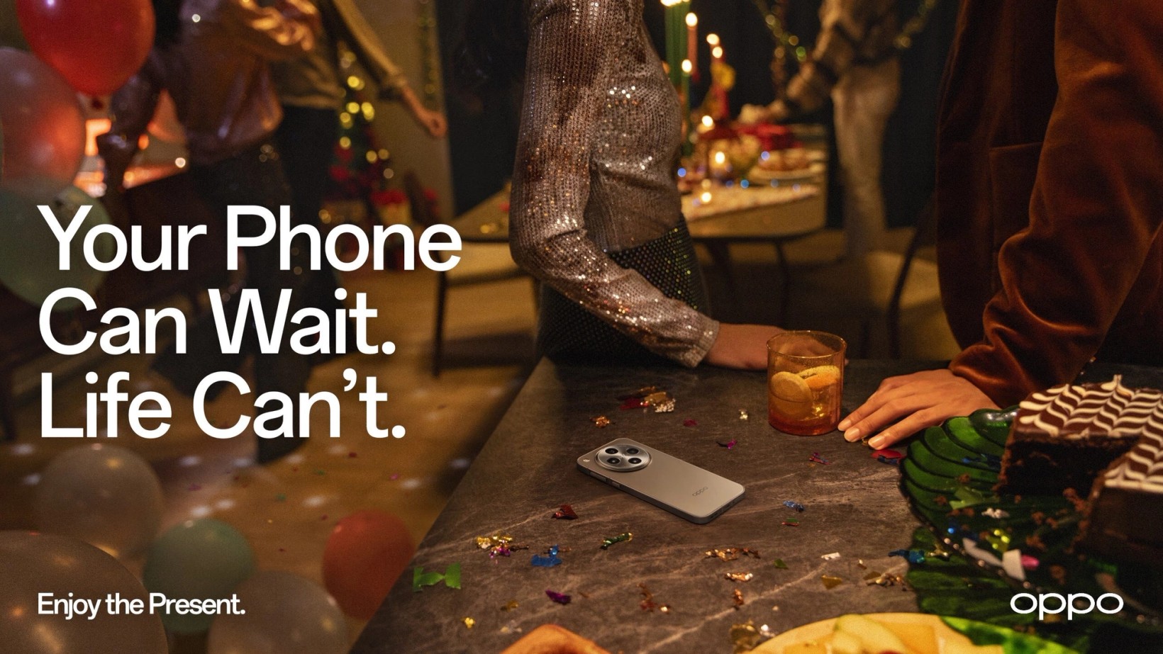 Key visual of a festive table with a phone left beside the plates