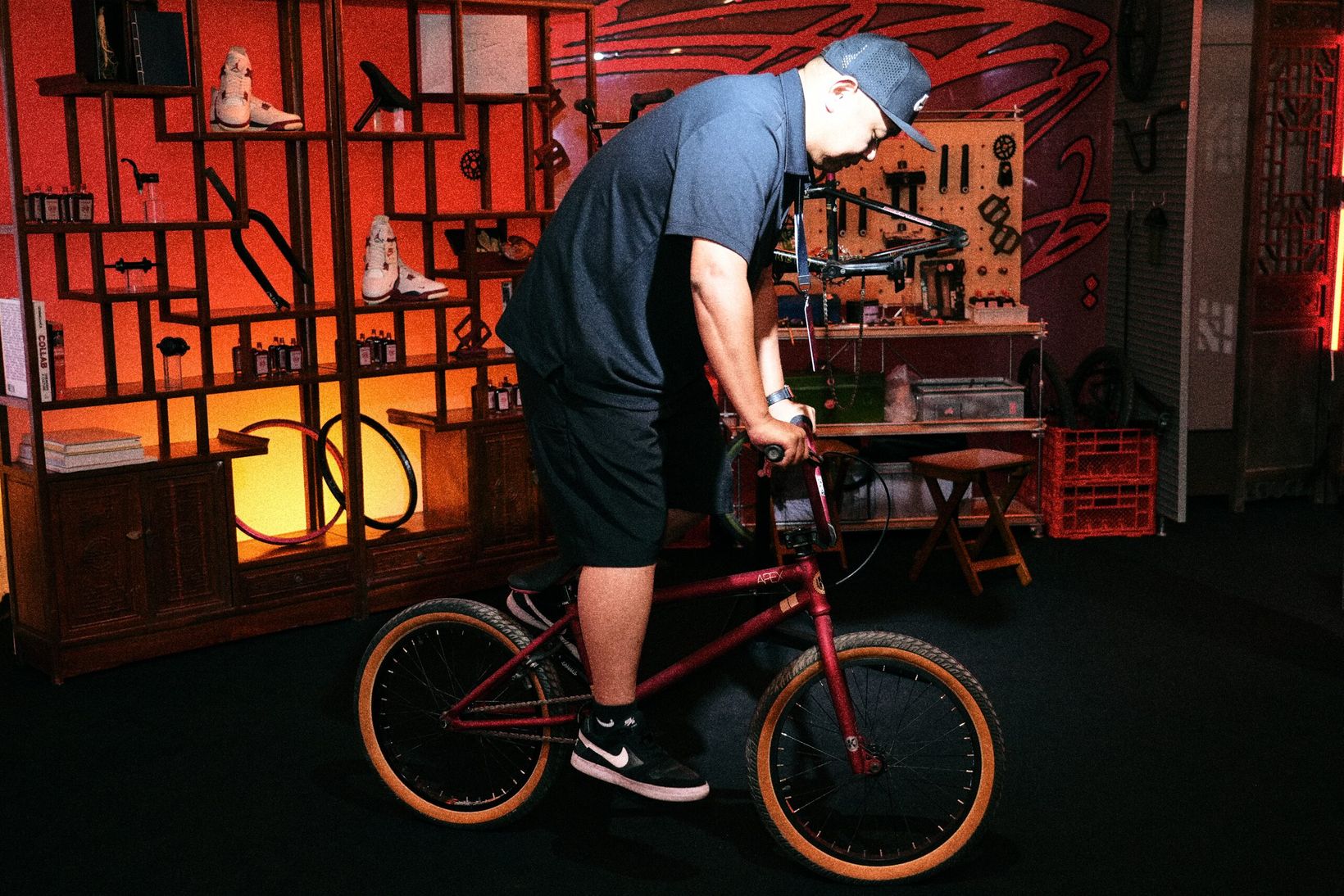 Rider on a BMX bike inside the clinic's recovery area