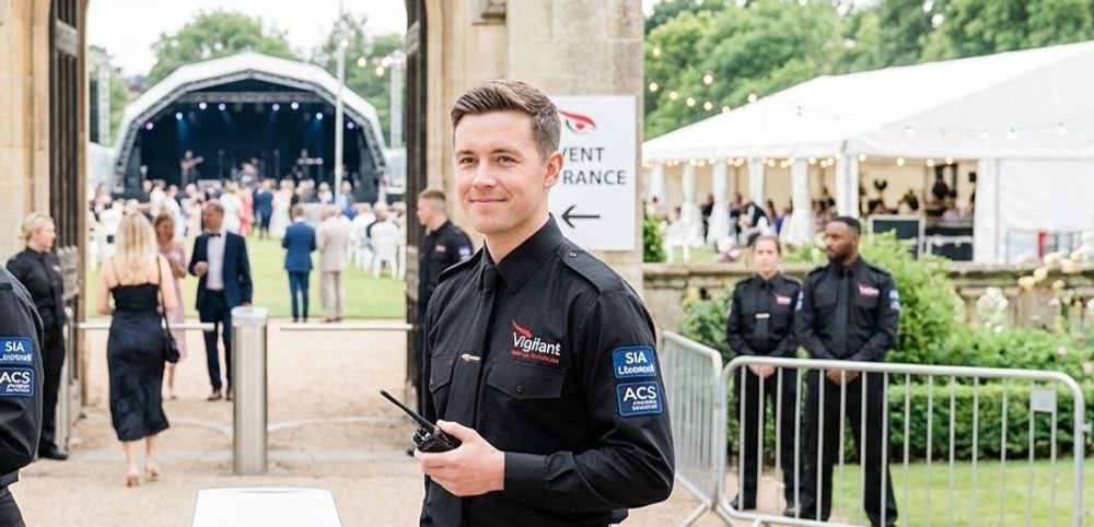 Event steward with a radio guiding guests at an outdoor venue