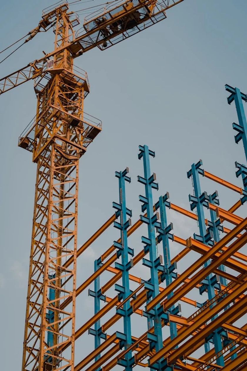 Steel frame and tower crane on an active UK construction site