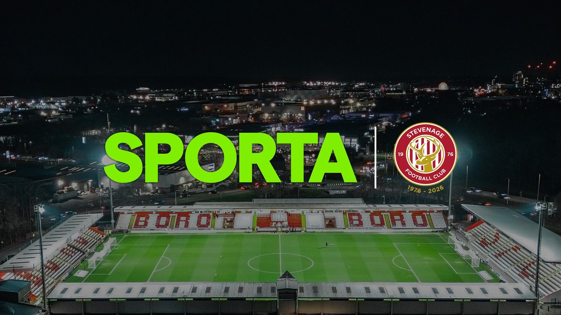 Logos of SPORTA and Stevenage FC against a backdrop of the SPORTA Arena at night.