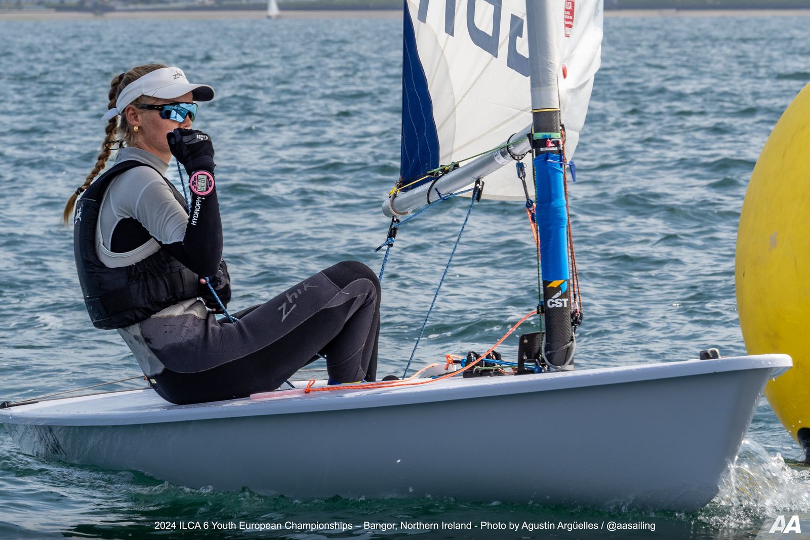 A solo female sailor on a small race boat.