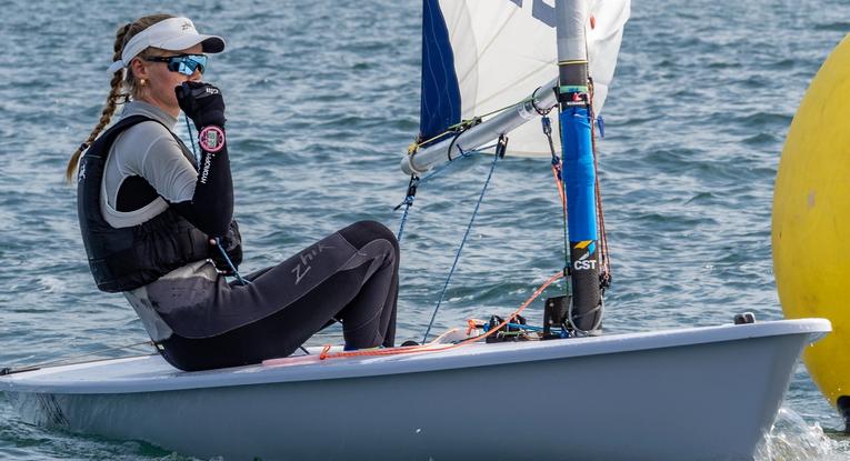 A solo female sailor on a small race boat.