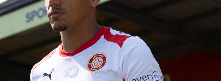 Image of Stevenage FC player and SPORTA Arena branding.