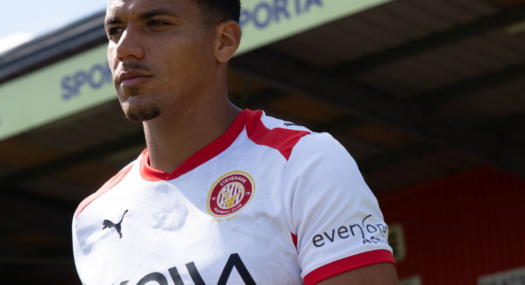 Image of Stevenage FC player and SPORTA Arena branding.
