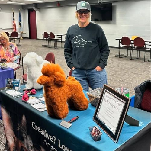 A Rio Grooming School representative at an information booth