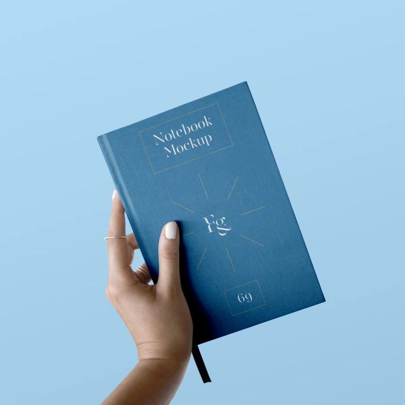 Hard Cover Notebook with Hand Mockup