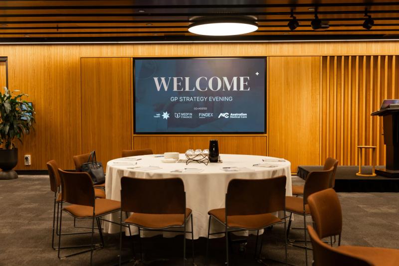 The room at the GP Strategy Evening — warm light, gathered colleagues.