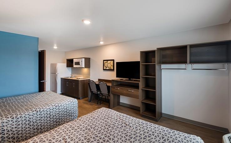 Two bedroom guest room layout at the WoodSpring Suites hotel in Austin, TX.