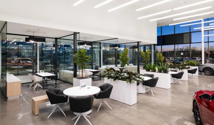 Customer tables beside glass offices.
