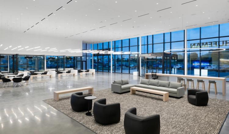 Wide Acura showroom with lounge seating.