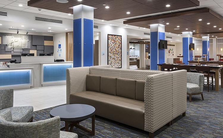 Seating area and front desk in lobby of Love's Hospitality-Holiday Inn in Brigham City, UT.