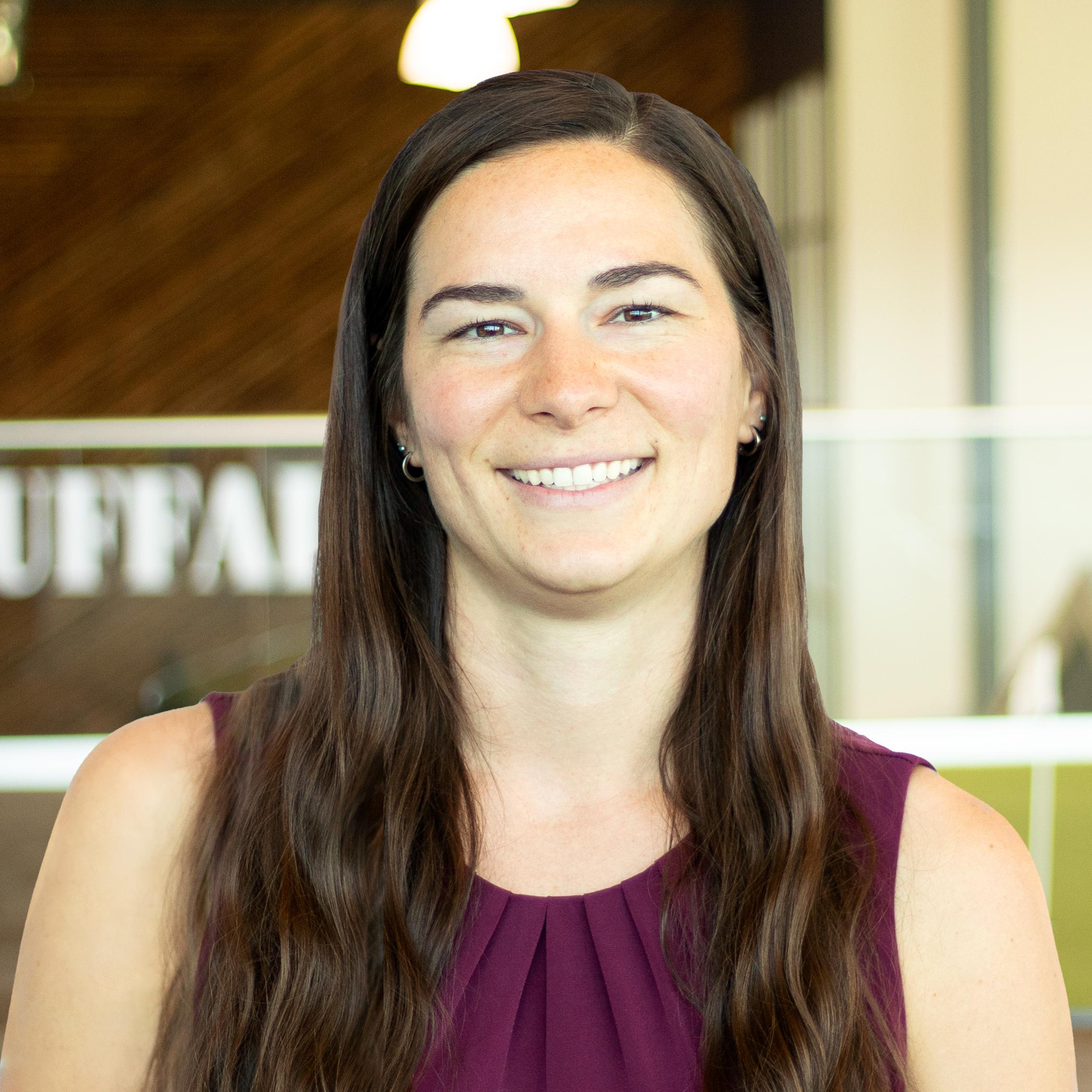 Julia Geraci smiling and standing in buffalo's office space.
