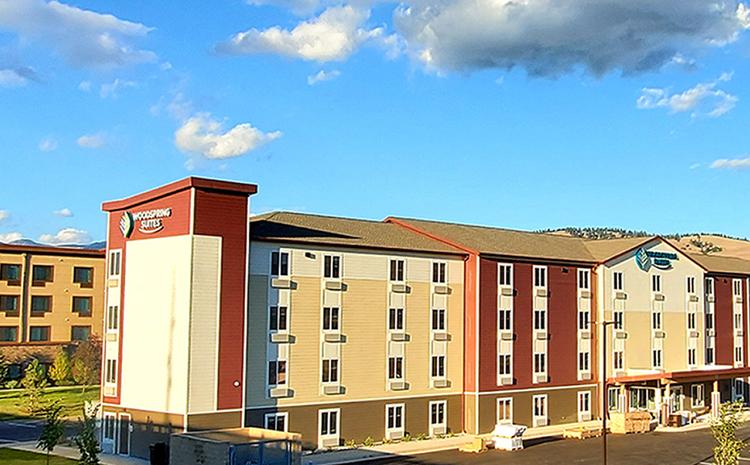 Exterior view of the WoodSpring Suites hotel in Missoula, MT.