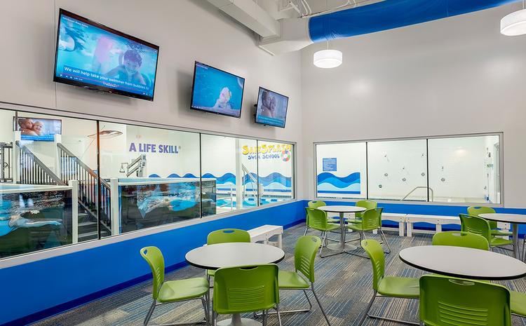 Seating area with pool view at Safe Splash.