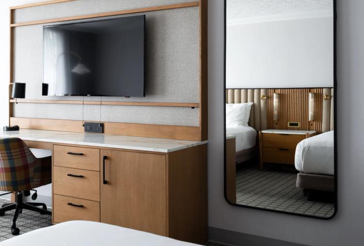 TV console and mirror in contemporary hotel room