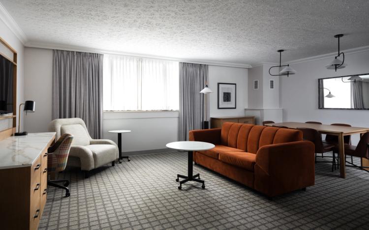 Suite with desk, sofa, and dining table area