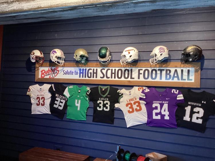 Local high school football decor on the walls inside of Bubba's 33 restaurant in Buford, GA.