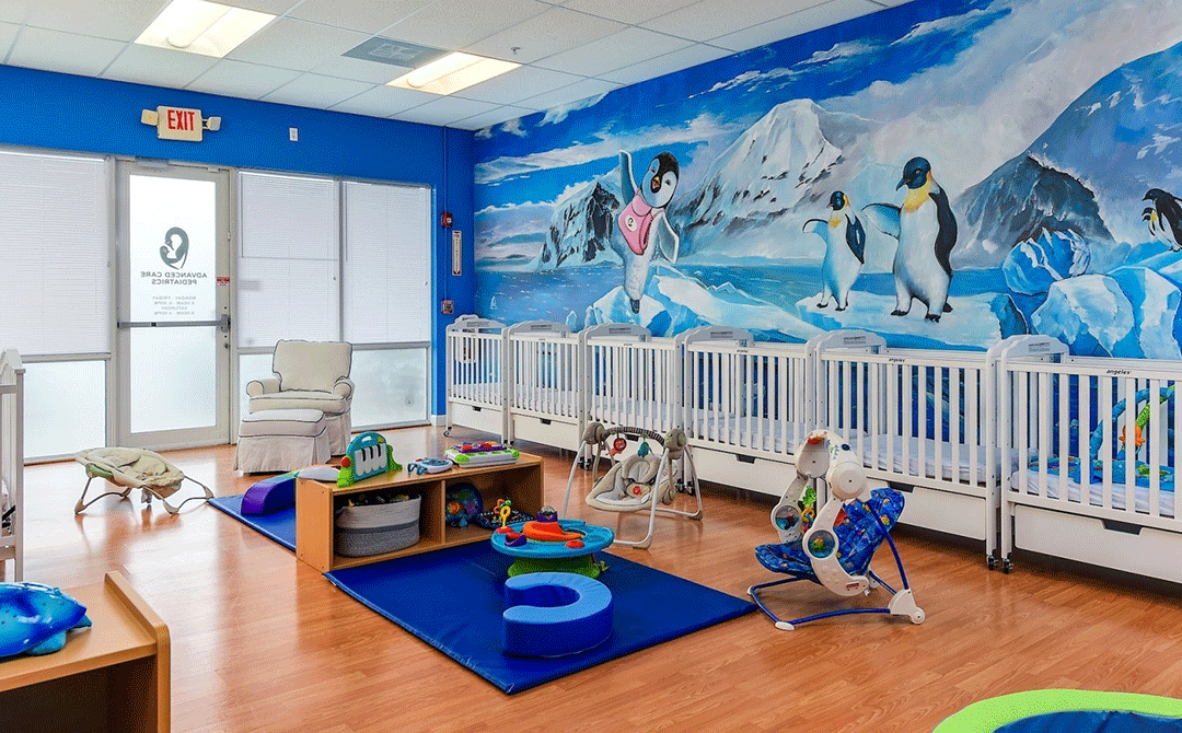 Crib and play area through the front door of the Advanced Care Pediatrics facility in Port St. Lucie, FL