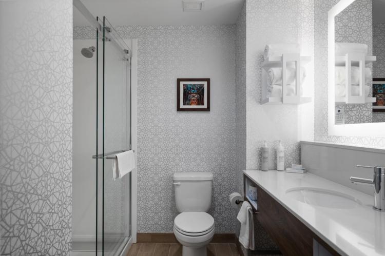 Guest room bathroom in Hampton Inn and Suites in Louisville, KY.