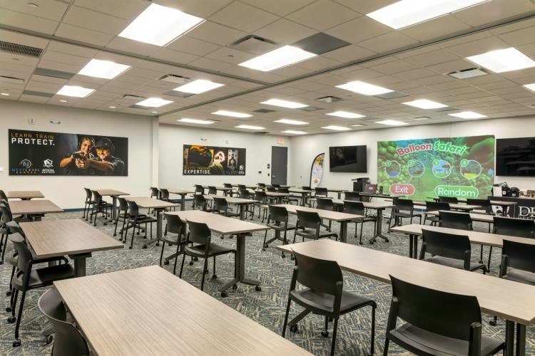 Expanded training room with branded wall graphics.