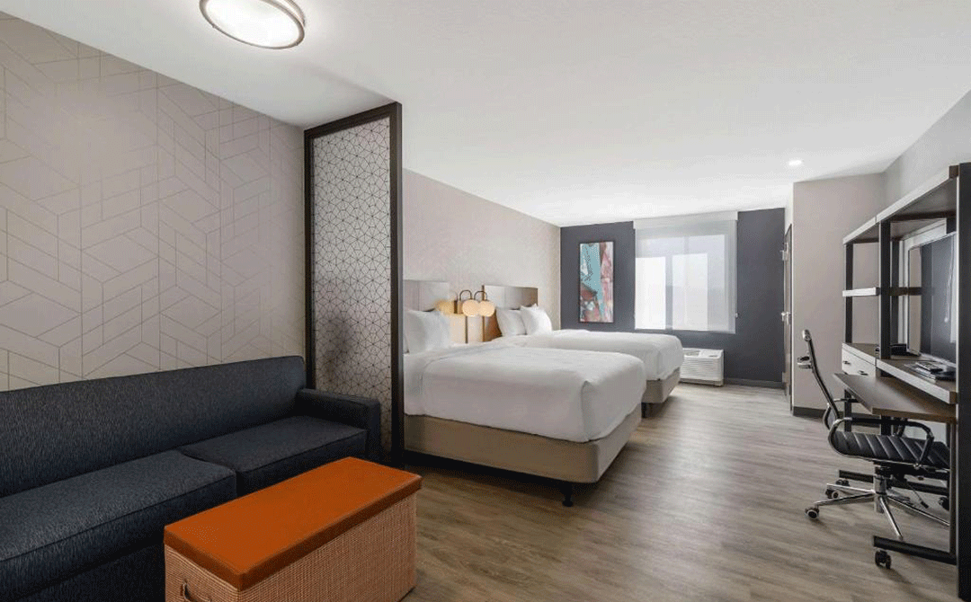 Guest bedroom in Everhome Suites hotel in Corona, CA.