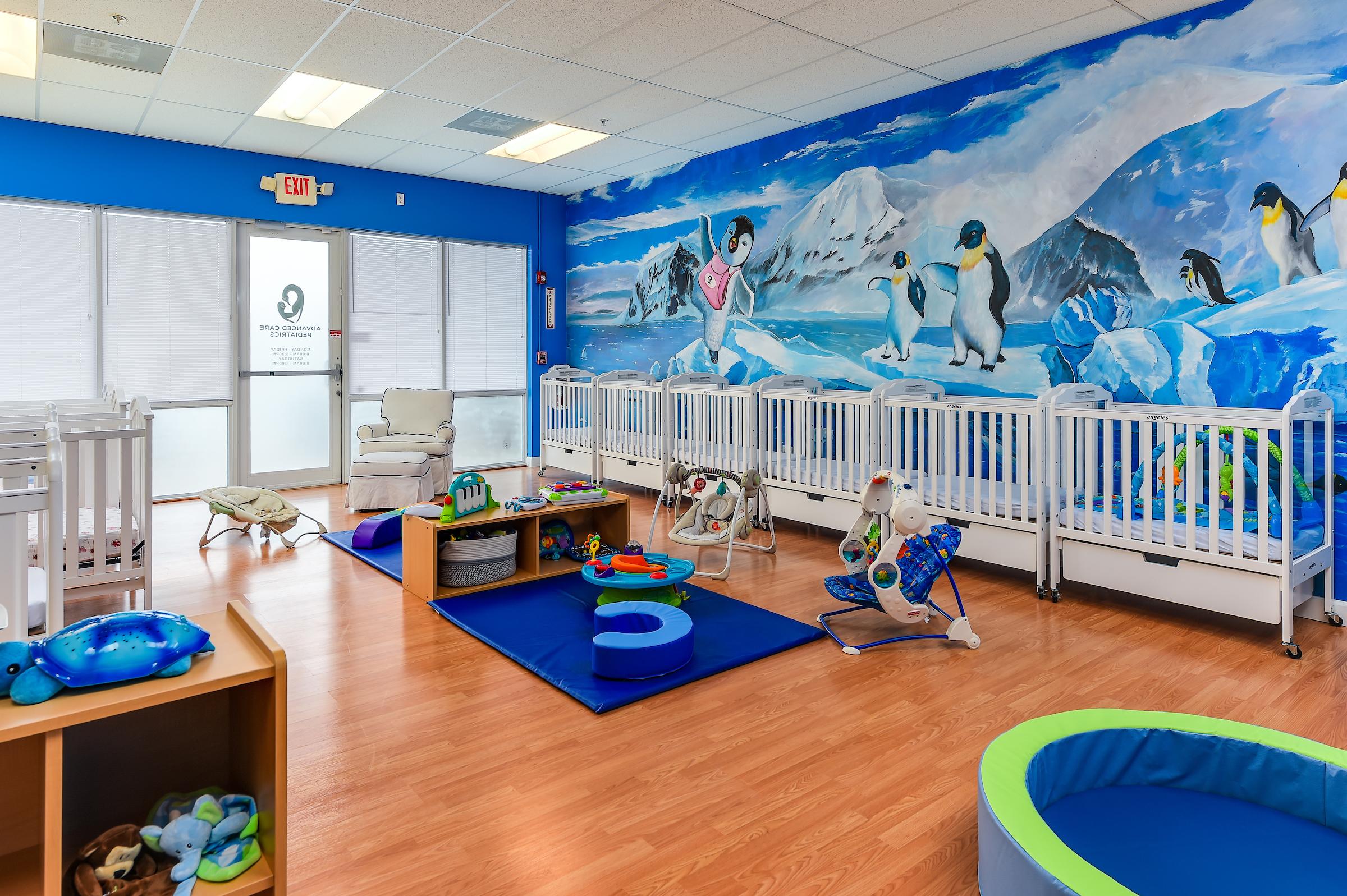 Crib and play area through the front door of the Advanced Care Pediatrics PPEC in Port St. Lucie, FL.