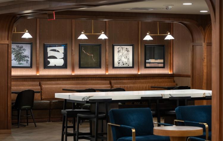 Art-lined dining alcove with wood-paneled walls