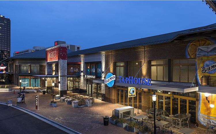 Exterior view of the Blue Moon Taphouse and Chipotle with patios at the Waterside District.