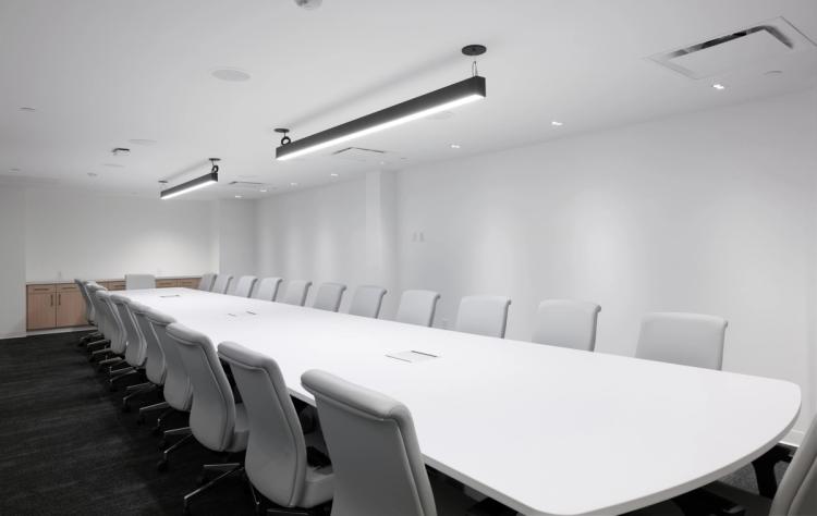 Bright conference room with white chairs.
