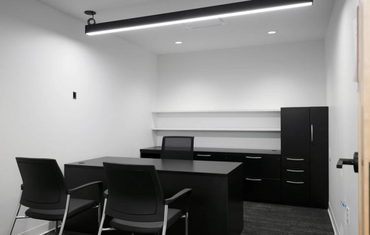 Private office with black desk and cabinets.