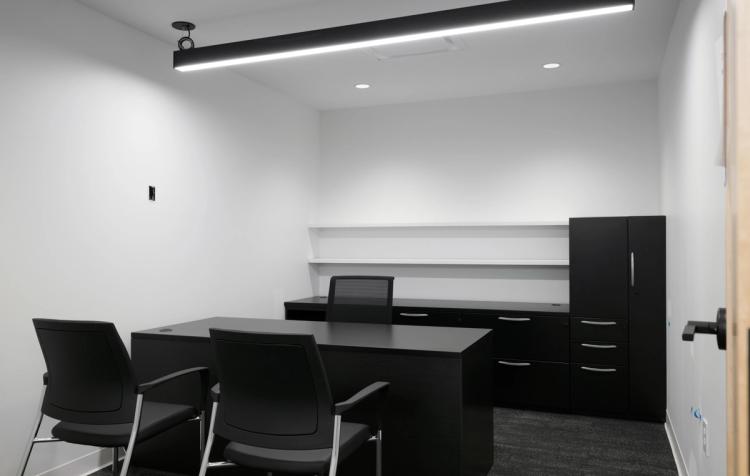 Private office with black desk and cabinets.