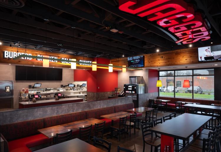 Counter and dining area inside of the Jaggers restaurant with Jaggers logo on the ceiling.