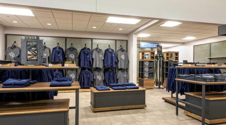 Branded apparel display in Next Level Ranges retail shop.