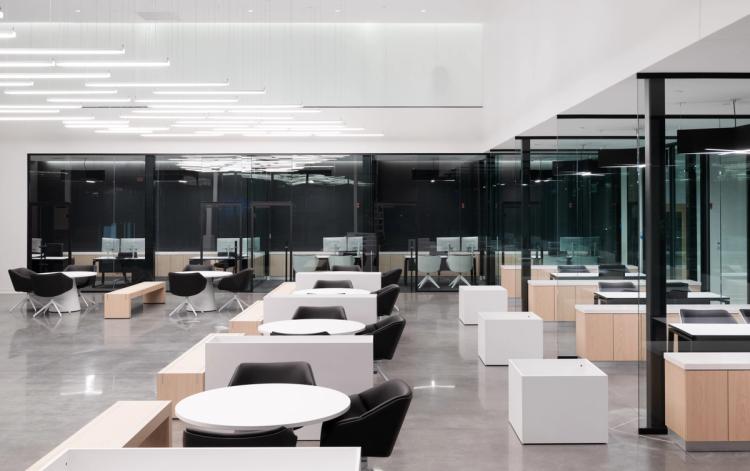 Modern showroom consultation area with glass offices.