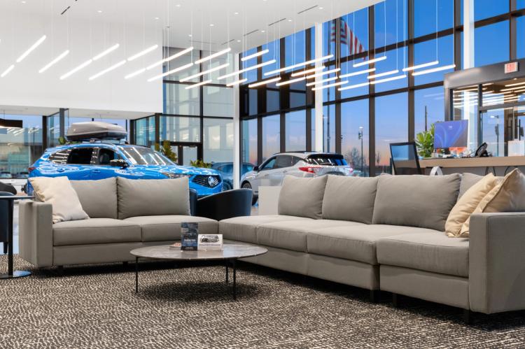 Lounge sofas with vehicles behind them.