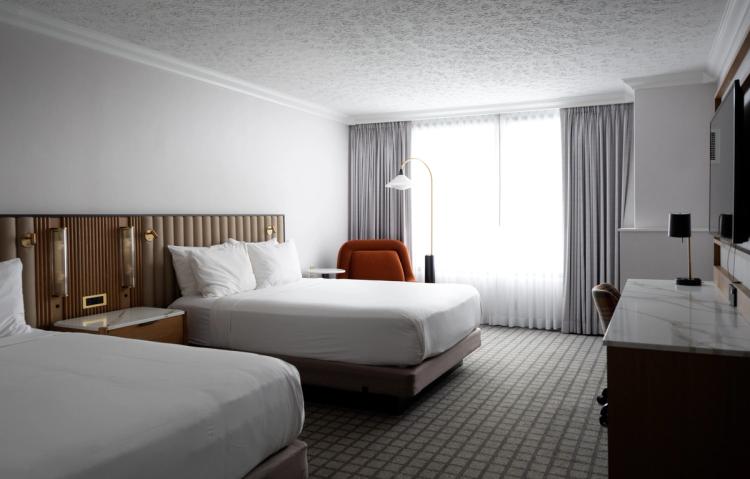 Double queen room with modern neutral finishes