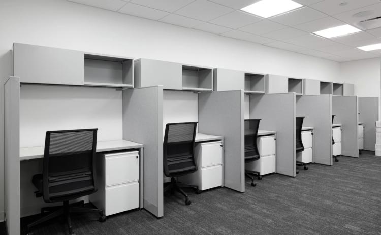 Office cubicles with gray partitions.