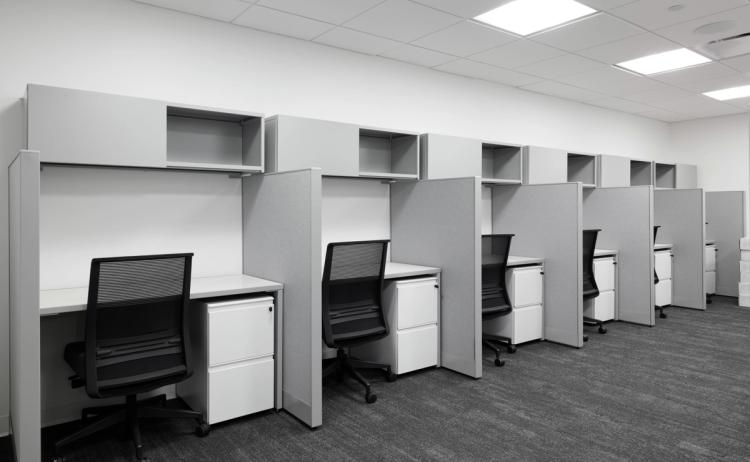 Office cubicles with gray partitions.