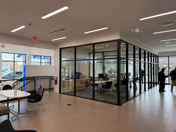After the renovation, the glass office area inside dealership.