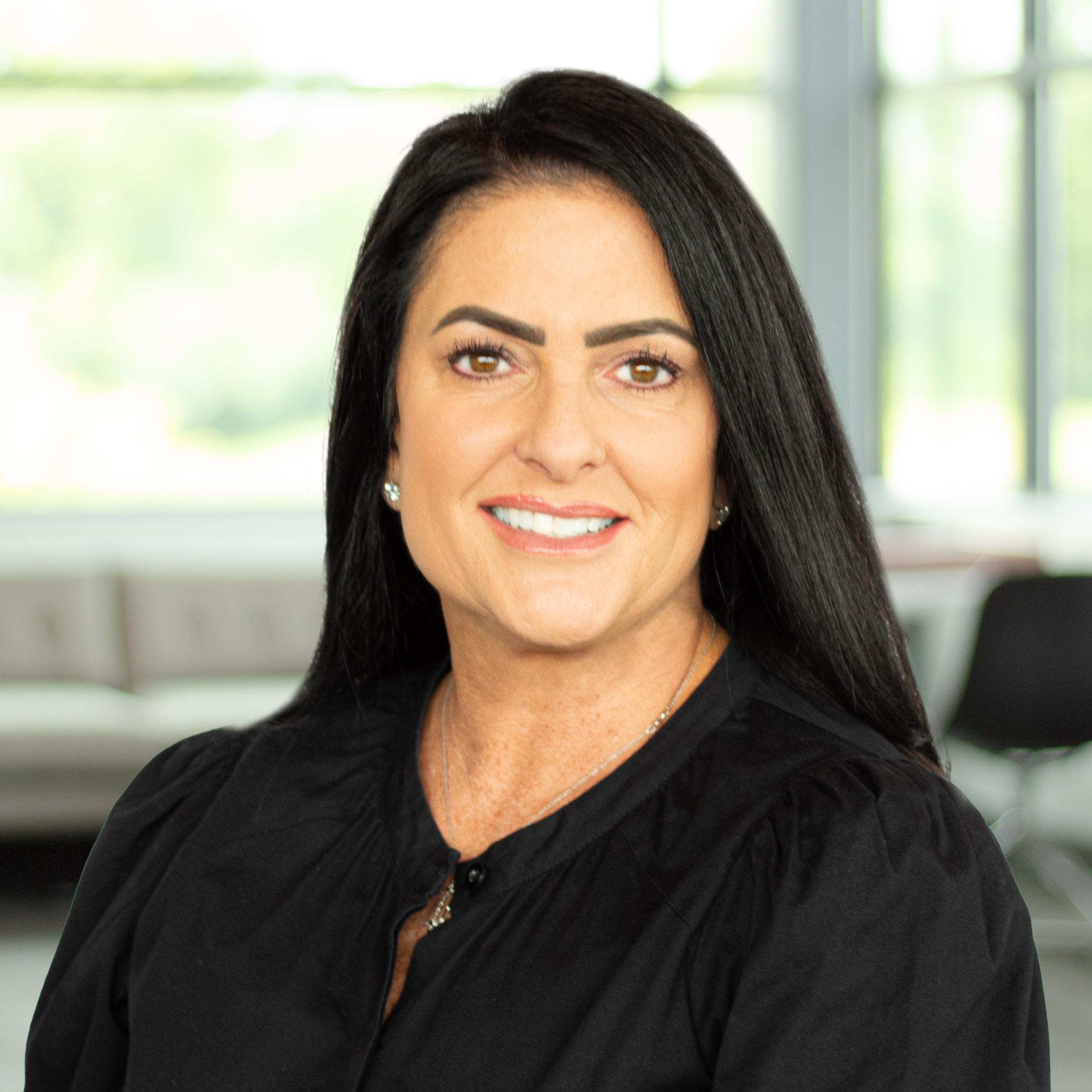 Jamie Gregor wearing a smile in a bright, modern office.